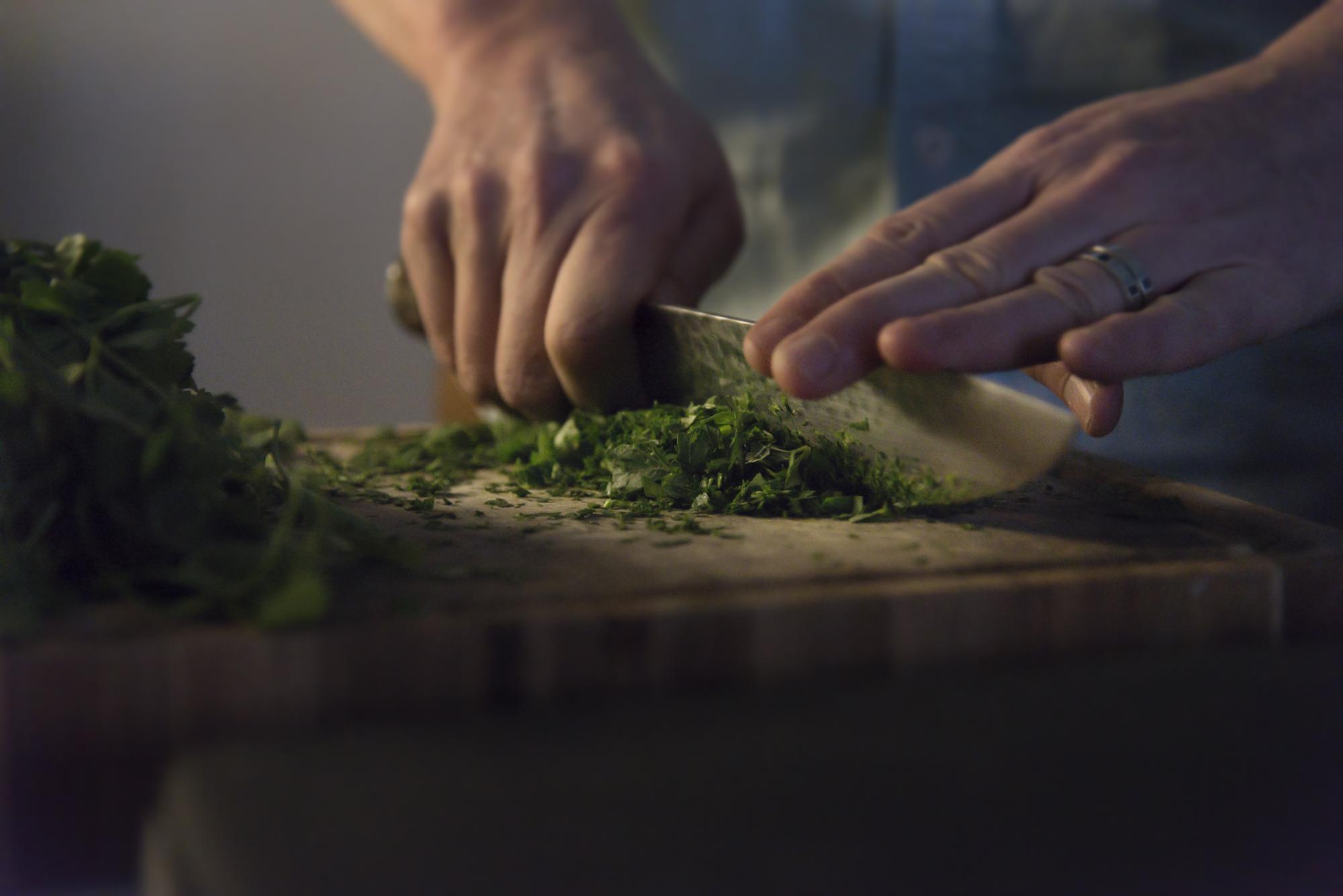 Close-up on hands preparing garnish